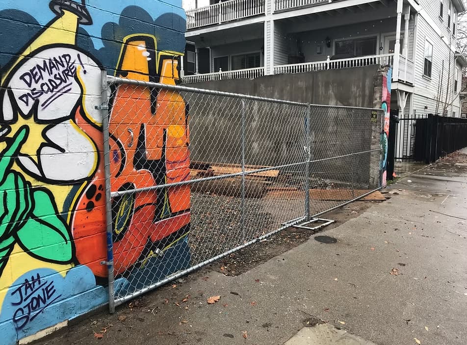 Team installing temporary fencing at a construction site